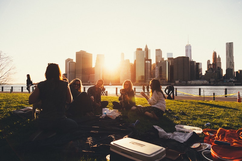 colivers enjoying a sunset in the park overlooking the skyline