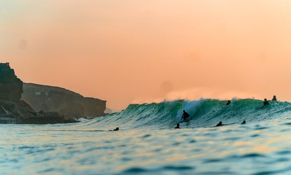 Surfing in Portugal sunset
