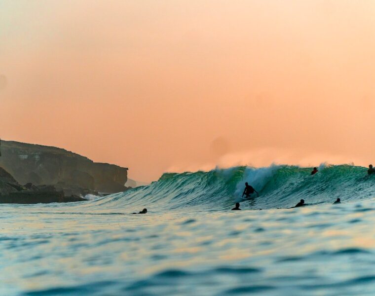 Surfing in Portugal sunset